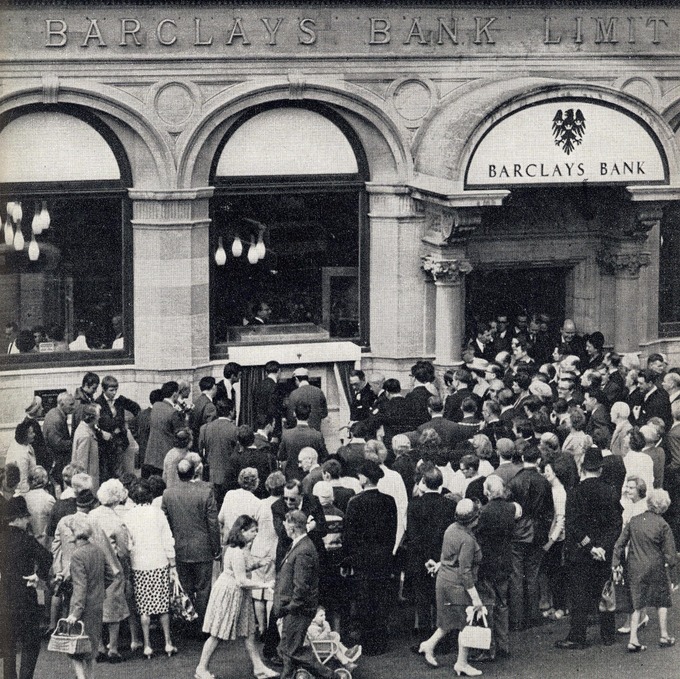 People scramble to get a look at the world's first ATM. Credit: PA Archive